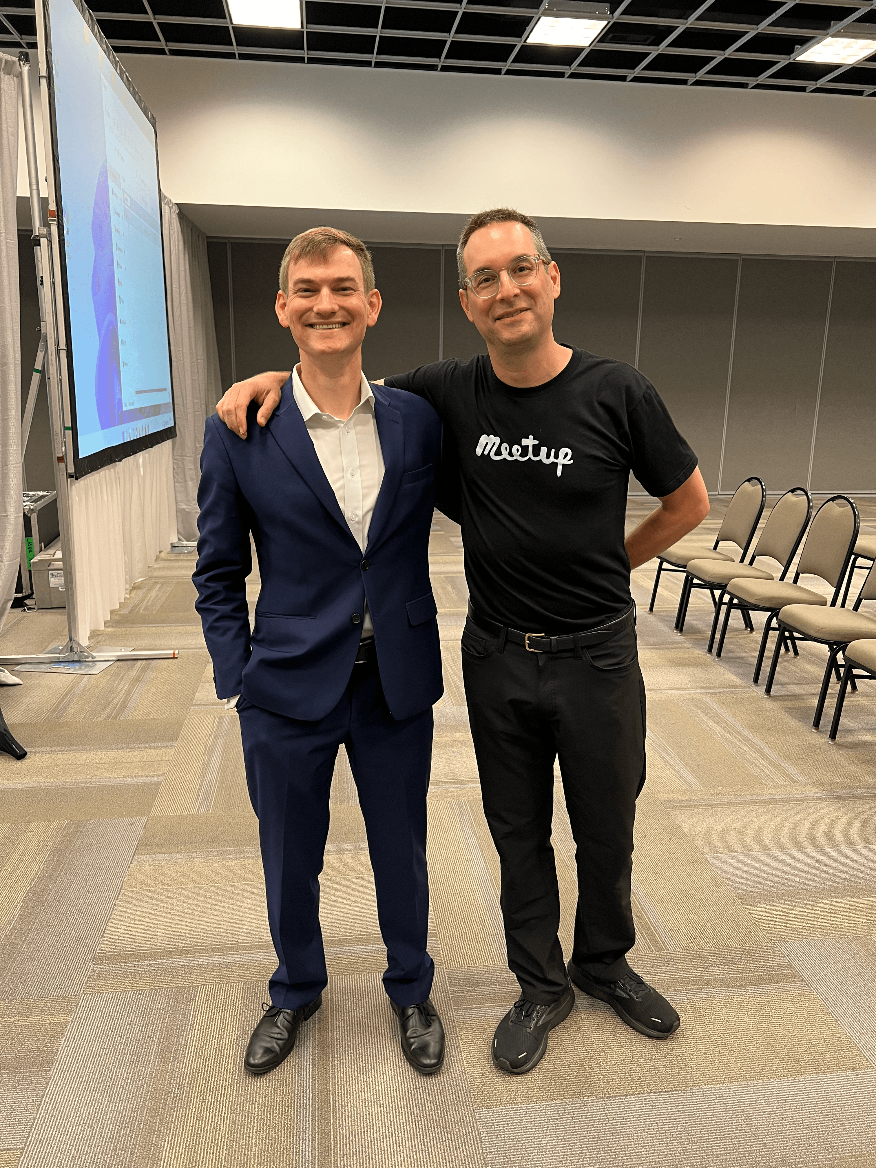 Nate posing with David Siegel, CEO of meetup, on stage at RenderATL 2023